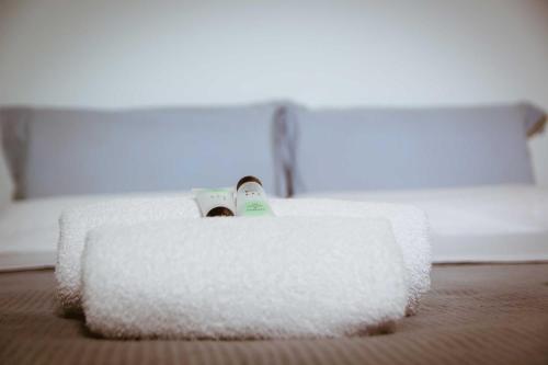 a person is laying in a bed with a towel at Traditional Apartments Elafos in Elafonisi