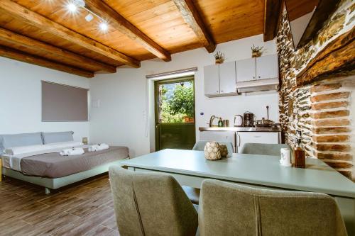 a room with a bed and a table and chairs at Traditional Apartments Elafos in Elafonisi
