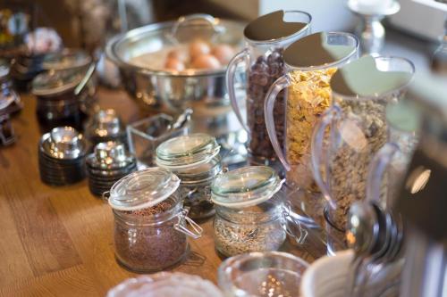 a wooden table topped with jars of food and nuts at Pension Andreashof in Gerlos