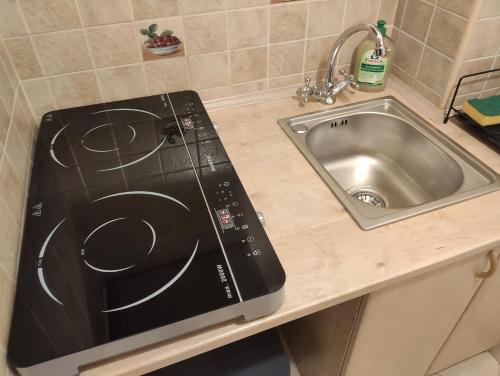 a kitchen counter with a sink and a stove at Comfortable Studio Old Town/New City in Warsaw
