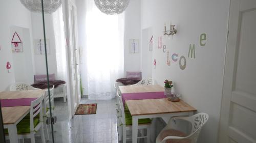 a dining room with two tables and a window at govienna - City Center Apartments in Vienna