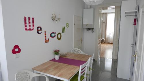 a small dining room with a wooden table and chairs at govienna - City Center Apartments in Vienna