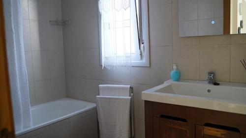 a bathroom with a sink and a bath tub and a sink at Solares Style vistas al rio MIERA in Solares