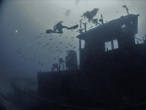 a group of people standing on top of a house at Tranquility Island Eco Dive Resort in Moso Island