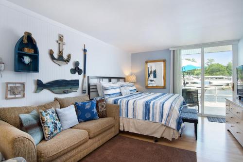 a bedroom with a bed and a couch at Waterside Suites in Saugatuck