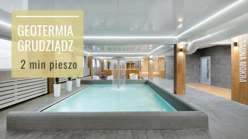 a swimming pool in a building with the words geocritic guatemala at Hotel Przy Solankach in Grudziądz