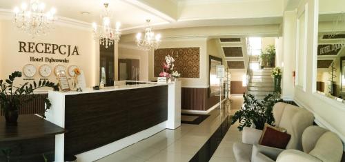 a store lobby with a counter and chandeliers at Hotel Dąbrowski in Oświęcim