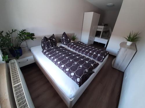 a bed in a living room with black pillows at SAV Ferienwohnung in Erfurt