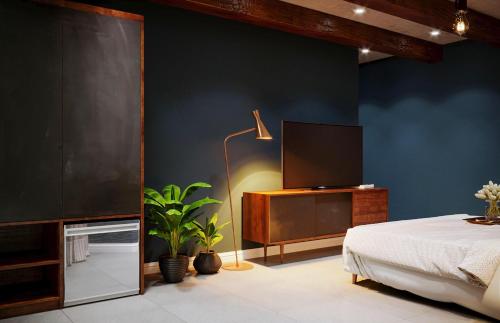 a bedroom with a bed and a flat screen tv at The wiltons hotel in Nam Ðịnh