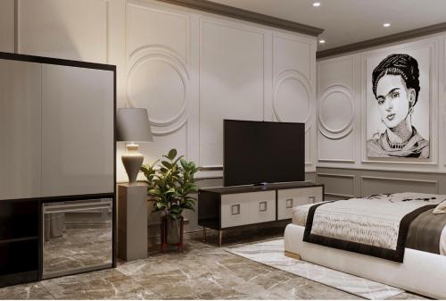 a bedroom with a bed and a flat screen tv at The wiltons hotel in Nam Ðịnh