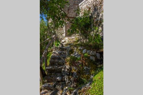 a stone staircase leading up to a house at La Caprareccia in Fiumata