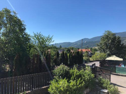 a fence in front of a garden with mountains in the background at Les Apparts de la Tourronde in Chorges