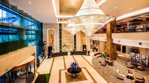 a large lobby with a large chandelier in a building at Holiday Inn Nanchang Riverside by IHG in Nanchang