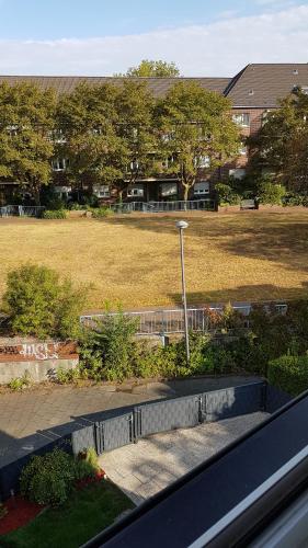 a view of a park with a field and a street light at Ferienwohnung am Stadion Bochum Grumme in Bochum