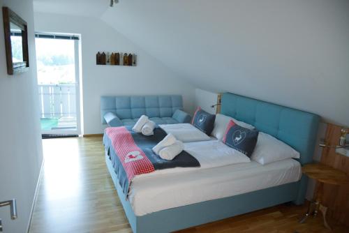 a blue bed with pillows on it in a room at Alpine Appartement Top 8 by AA Holiday Homes in Tauplitz