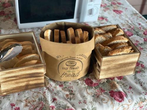 two boxes of different types of bread on a table at Villa Rural Sierra Hueznar in El Pedroso