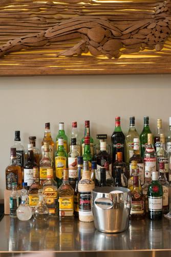 a bunch of bottles of alcohol sitting on a counter at Olympic Hotel in Heraklio Town
