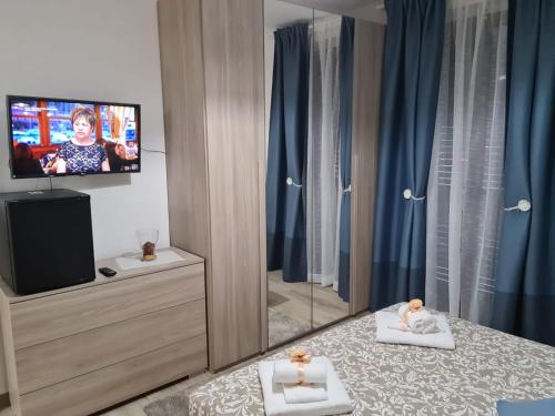 a living room with a tv and a room with at B&B Villa Chiara - Bed And Breakfast in Taormina