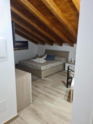 a bedroom with a bed in a room with wooden ceilings at B&B Villa Chiara - Bed And Breakfast in Taormina