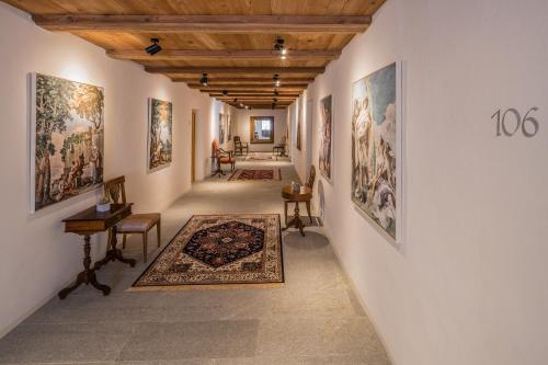 a hallway of a museum with paintings on the walls at Residence Traube in Bressanone