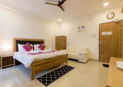a bedroom with a large bed and a couch at Rainforest Resort and Spa, Igatpuri -Nature's Luxury Awaits in Igatpuri