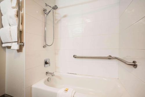 a bathroom with a shower and a tub and a toilet at La Quinta by Wyndham Grants Pass in Grants Pass