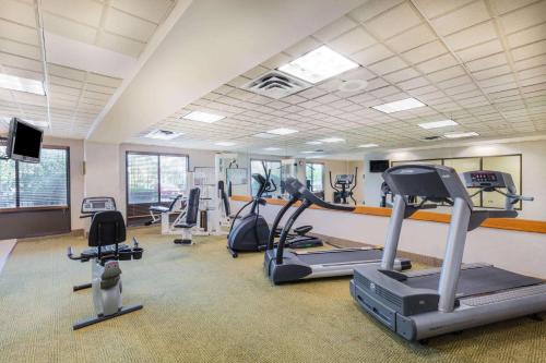 a gym with treadmills and ellipticals in a room at La Quinta by Wyndham Garden City in Garden City