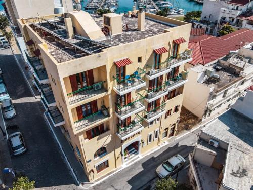 a very tall building with a lot of windows at Mantraki Hotel Apartments in Agios Nikolaos
