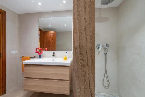 a bathroom with a sink and a shower at Estrel in Can Picafort