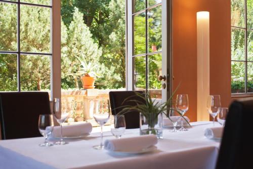 a table with white table cloths and wine glasses at Schlosshotel Ziethen in Kremmen