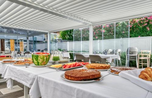 a table with cakes and other food on it at Horizon Suites in Cefalù