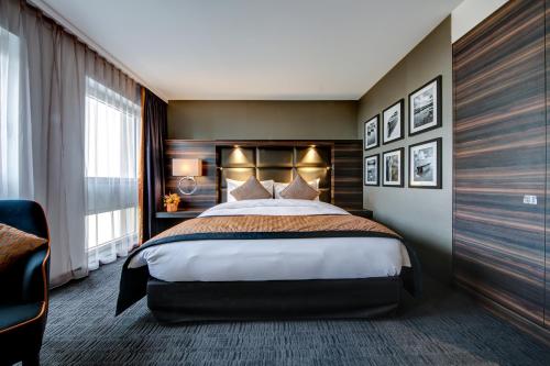 a hotel room with a bed and a window at Hotel Beaulac in Neuchâtel