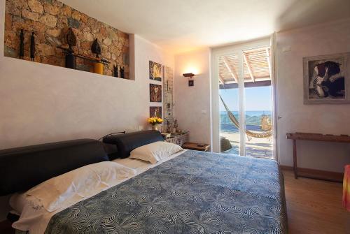 a bedroom with a bed with a view of the ocean at Villa Pina in Magliolo