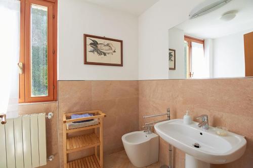 a bathroom with a sink and a toilet in it at Villa Pina in Magliolo