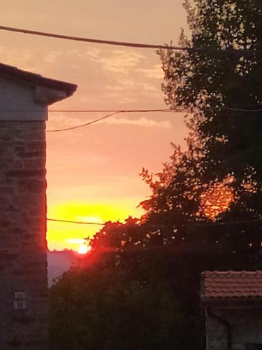 a sunset is seen through a window of a house at Fra Bosco e Cielo B&B in Mercato Saraceno
