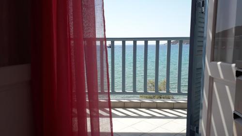a room with a view of the ocean from a balcony at Kyprianos house in Platis Yialos Sifnos