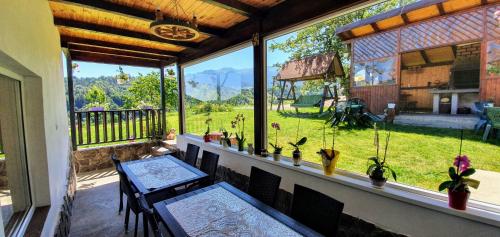 a screened in porch with a table and chairs at Casa Elena in Bran