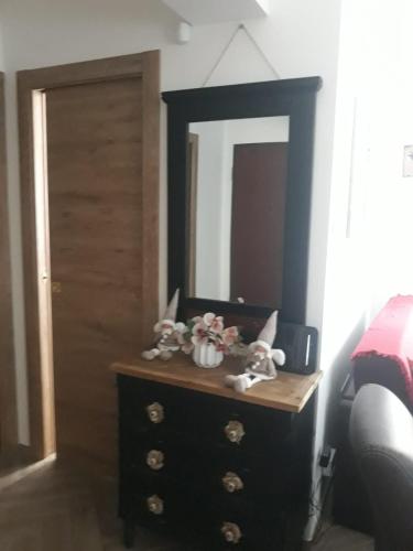 a dresser with a mirror and some stuffed animals on it at Piccolo Paradiso in pieno centro Pescocostanzo in Pescocostanzo