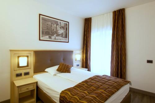 Postel nebo postele na pokoji v ubytování Hotel Portici - Romantik & Wellness