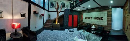 a living room with a table and chairs in a building at Cozy Loft with Balcony in Mexico City