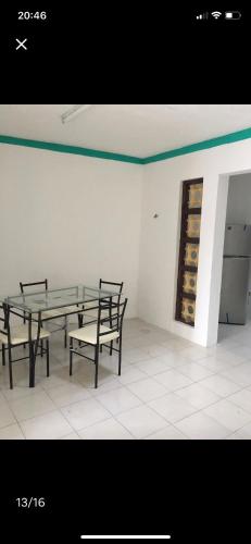 a table and benches in a room with wine bottles at Casa Colonial Centro in Mérida