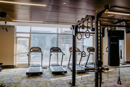 a gym with several treadmills in front of a window at Kasa The Gulch Nashville in Nashville