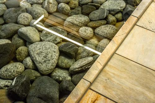 a pile of rocks and wooden sticks on a floor at Apartment Enzian mit Mitbenutzung SPA & Wellness - GRIWA RENT AG in Beatenberg