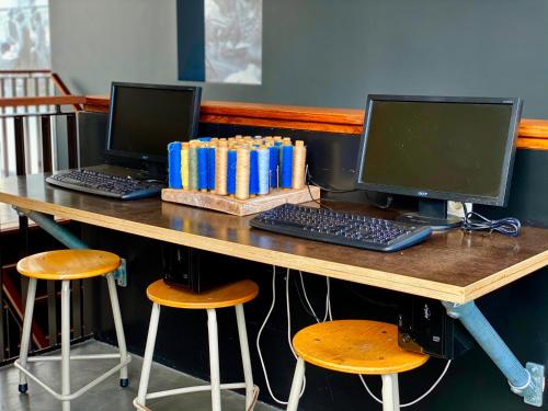 
a desk with three laptops on it at Hotel Nijver in Geldrop
