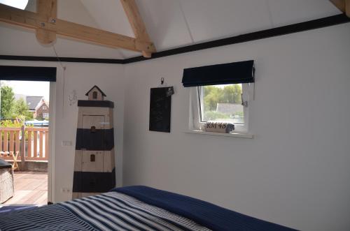 a bedroom with a bed and a window at Froukje's B&B in Woerdense Verlaat
