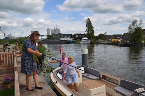 a woman in a boat with a group of people at Froukje's B&B in Woerdense Verlaat