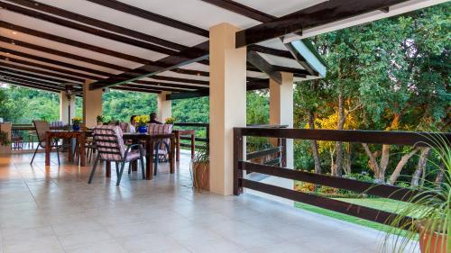 a patio with a table and chairs on it at Cuckoo Ridge Country Retreat in Hazyview