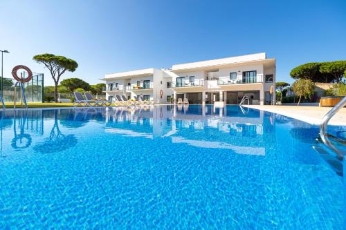 a large swimming pool in front of a building at Complejo Al Sur in Chiclana de la Frontera