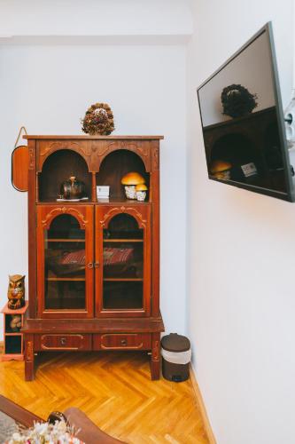 a wooden cabinet with a tv in a room at Casa Vinco Vici in Turda