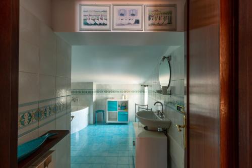 a bathroom with a sink and a mirror at Vacanze al Mare Patrizia's Sweet Home in Terme Vigliatore